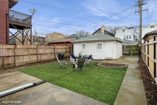 back of property featuring a yard and an outdoor structure