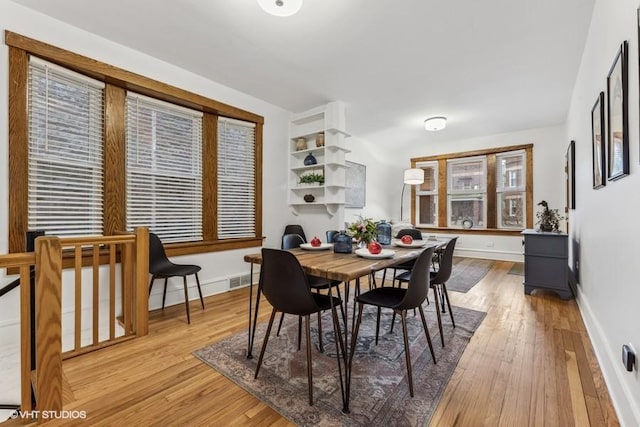 dining space with light hardwood / wood-style flooring