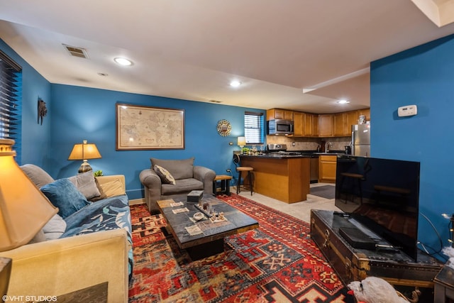 carpeted living room featuring sink