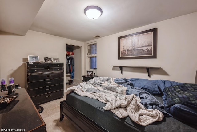 bedroom featuring a spacious closet and a closet