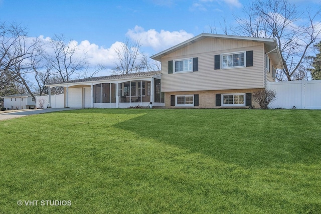 tri-level home with a front yard, a sunroom, and a carport