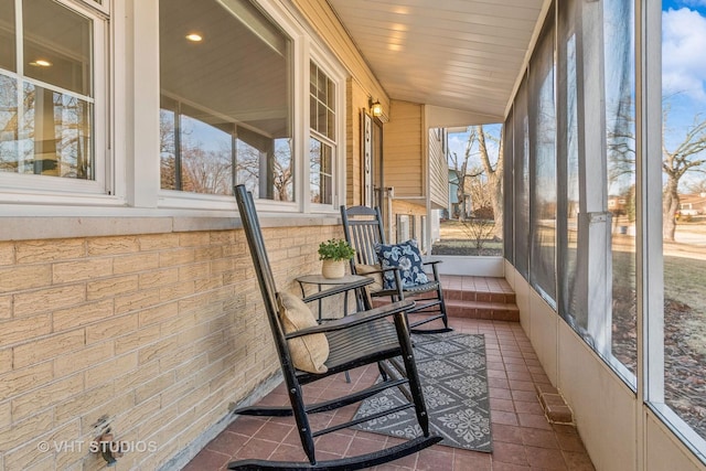 sunroom / solarium featuring lofted ceiling and wooden ceiling