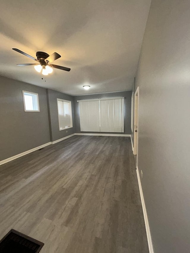 spare room with ceiling fan and dark hardwood / wood-style flooring