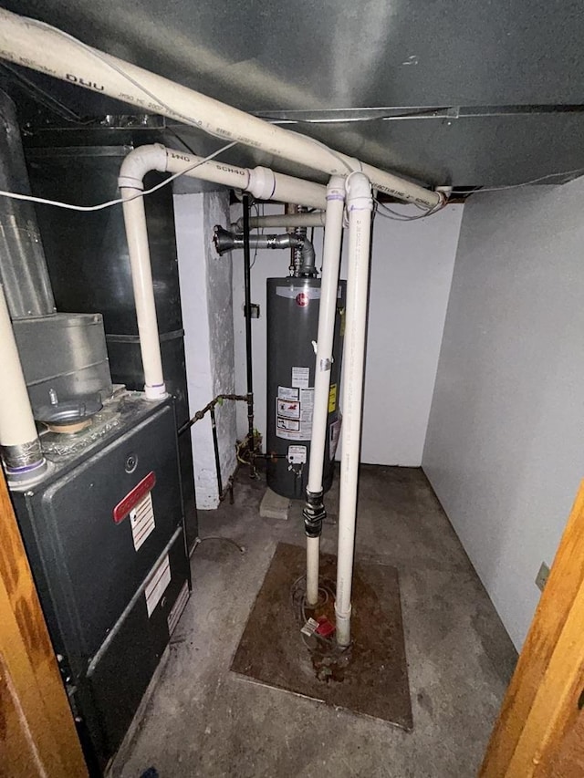 utility room featuring heating unit and water heater