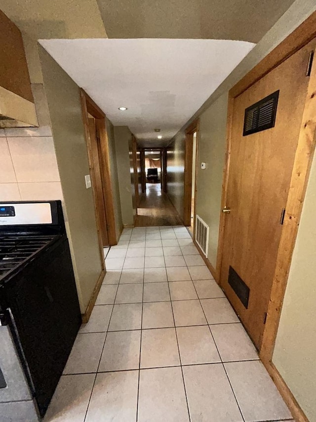 hall featuring light tile patterned floors