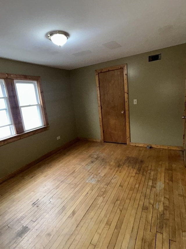 spare room featuring light hardwood / wood-style flooring