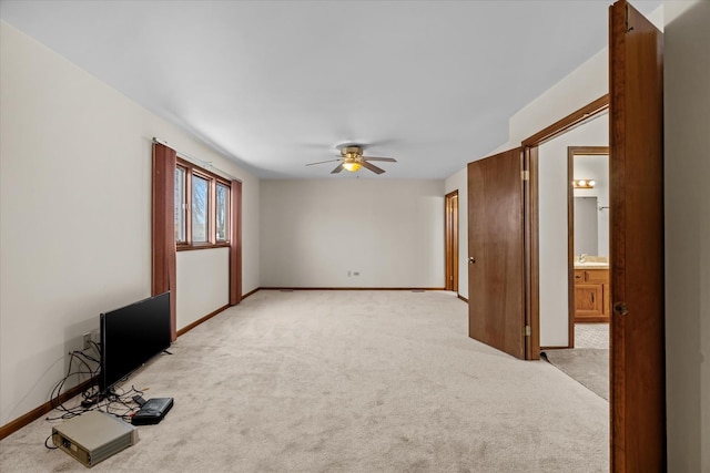 interior space featuring ceiling fan, light colored carpet, and sink