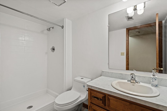 bathroom with toilet, vanity, and walk in shower