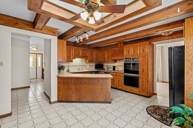 kitchen with ceiling fan, tasteful backsplash, black appliances, kitchen peninsula, and sink