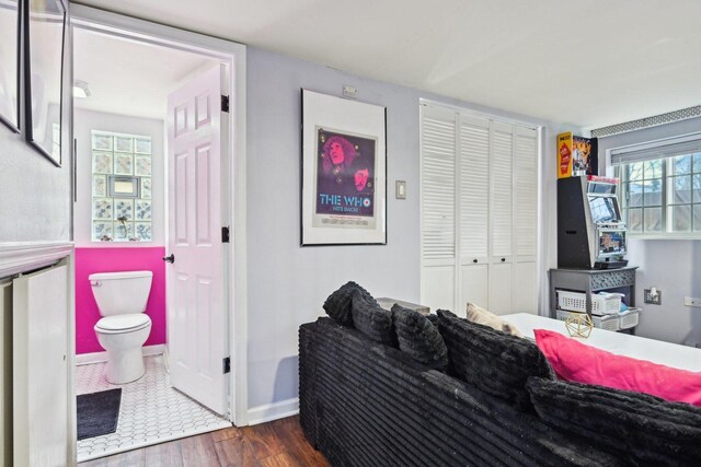 bedroom with dark hardwood / wood-style floors