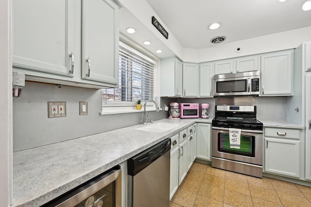 kitchen featuring wine cooler, sink, and stainless steel appliances