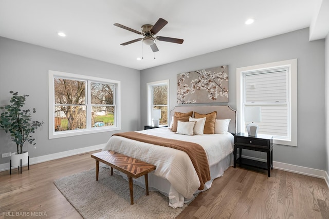 bedroom with ceiling fan and light hardwood / wood-style floors