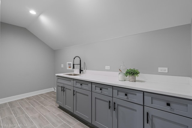 interior space featuring cabinets, washer hookup, and sink