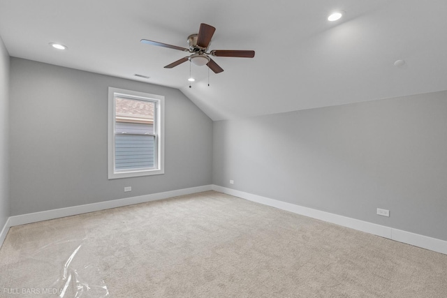 additional living space with ceiling fan, light carpet, and vaulted ceiling