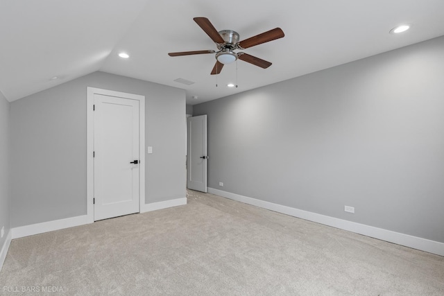 unfurnished bedroom featuring ceiling fan, light colored carpet, and lofted ceiling