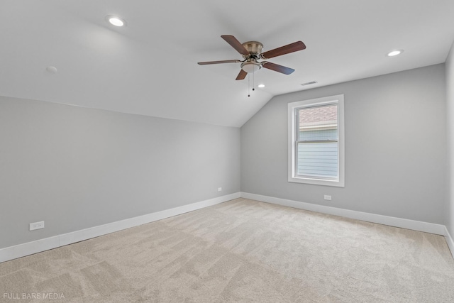 additional living space featuring light carpet, vaulted ceiling, and ceiling fan