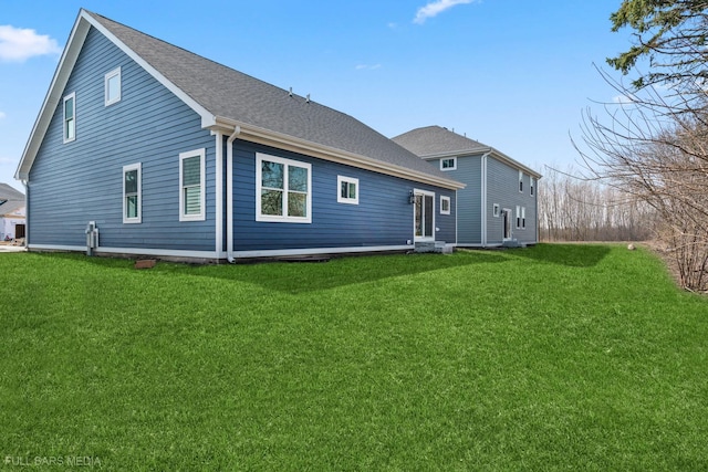 back of property with a lawn