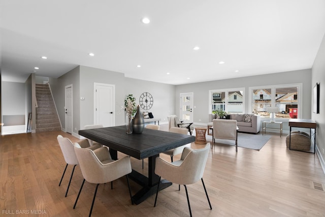 dining space with light hardwood / wood-style flooring