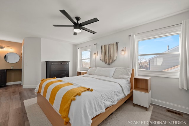 bedroom with wood-type flooring and ceiling fan