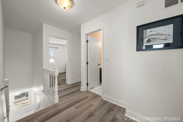 corridor with light hardwood / wood-style floors