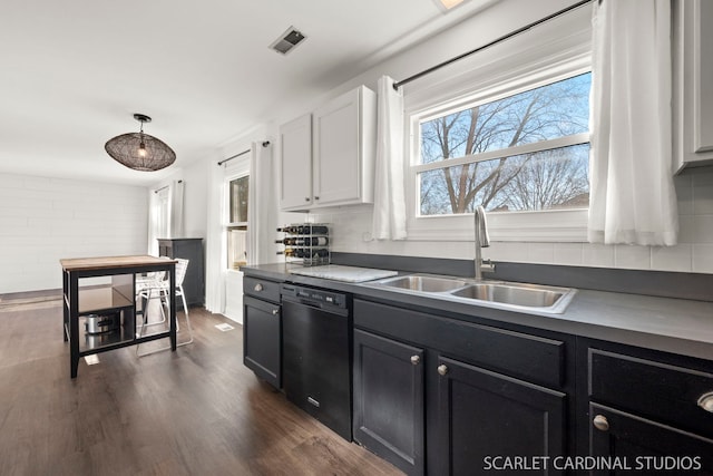 kitchen featuring dark hardwood / wood-style floors, decorative light fixtures, white cabinetry, dishwasher, and sink