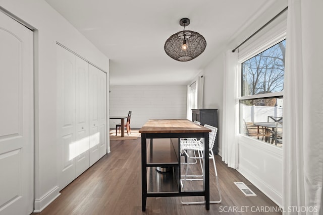 dining space featuring dark hardwood / wood-style flooring