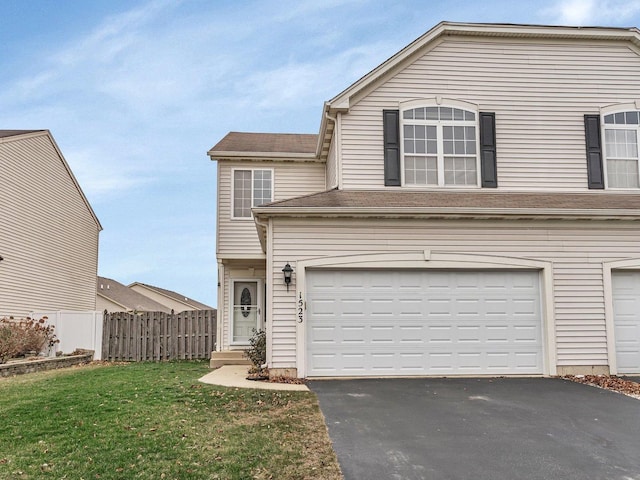 front of property featuring a front yard and a garage