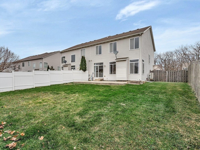 rear view of house featuring a yard and a patio