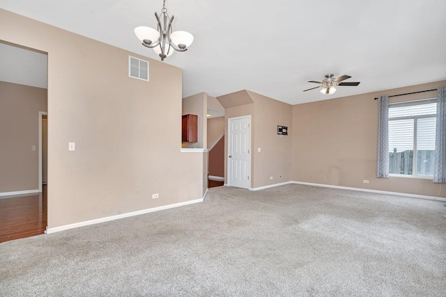 empty room featuring ceiling fan with notable chandelier and carpet floors