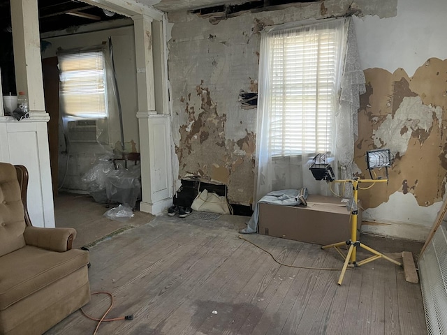 living area with hardwood / wood-style floors and cooling unit