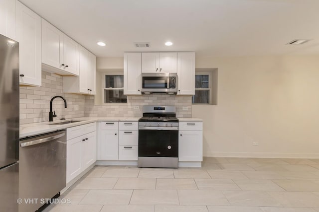 kitchen featuring white cabinets, sink, and stainless steel appliances