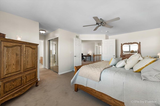 carpeted bedroom with ceiling fan and a closet