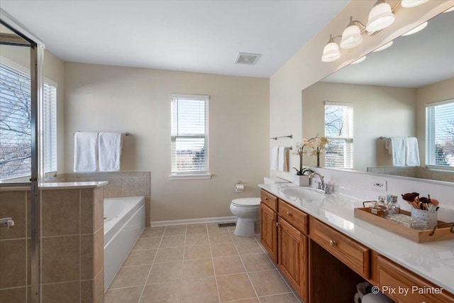 bathroom with tile patterned flooring, vanity, a bathtub, and toilet