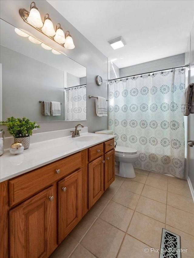 bathroom with tile patterned flooring, vanity, and toilet