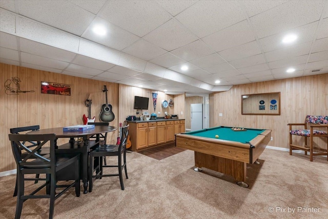 rec room featuring wood walls, carpet floors, billiards, and a drop ceiling