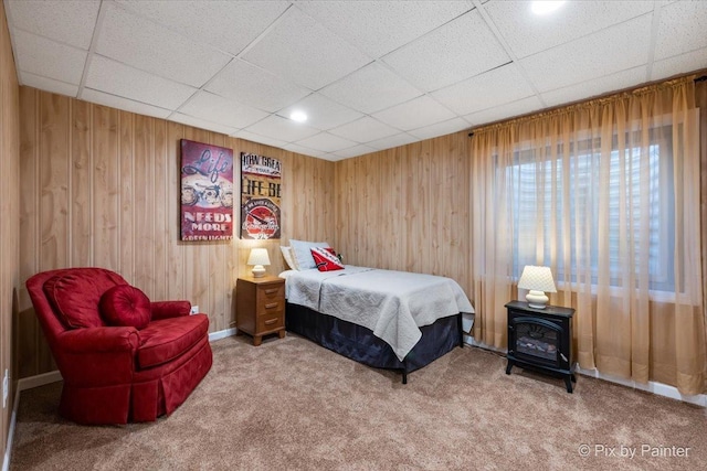 carpeted bedroom with wooden walls