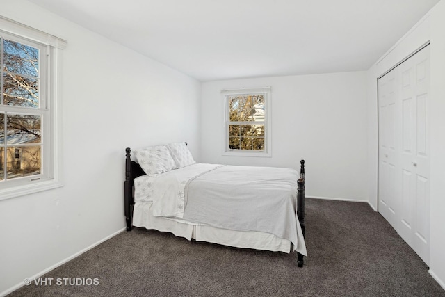 bedroom featuring dark carpet and a closet