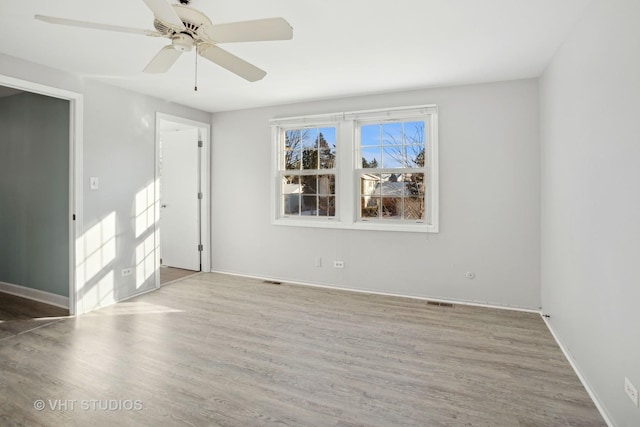 spare room featuring ceiling fan and light hardwood / wood-style flooring