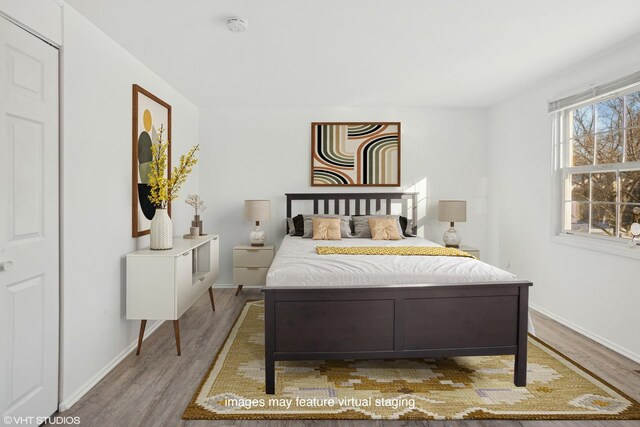 bedroom with hardwood / wood-style flooring