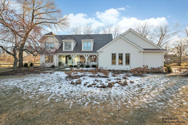 cape cod-style house with a porch