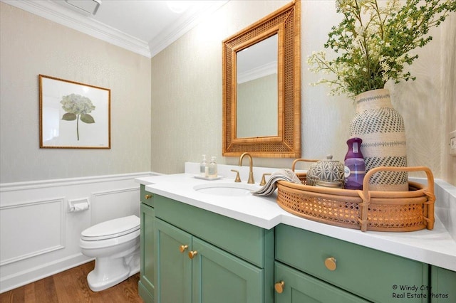 bathroom featuring ornamental molding, hardwood / wood-style floors, vanity, and toilet