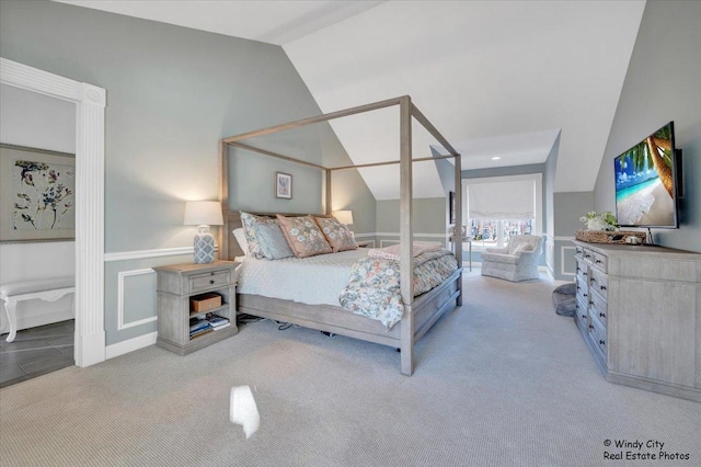 bedroom with lofted ceiling and light carpet