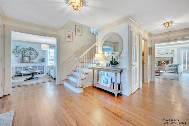 interior space with crown molding, hardwood / wood-style flooring, and a fireplace