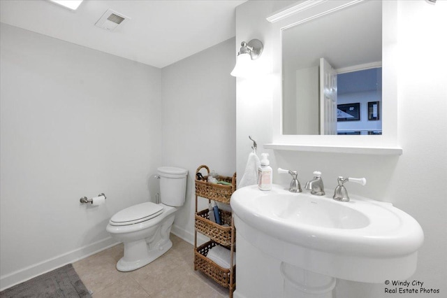 bathroom with sink, tile patterned floors, and toilet