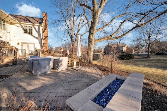 view of patio / terrace featuring an outdoor fire pit