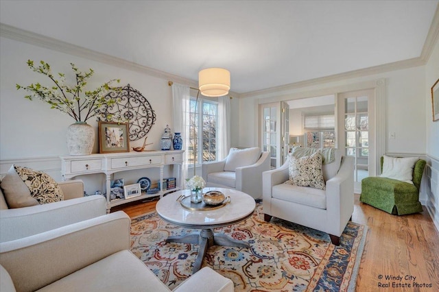 living room with crown molding and light hardwood / wood-style flooring