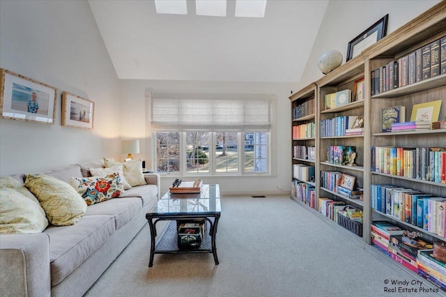 living room with vaulted ceiling and carpet