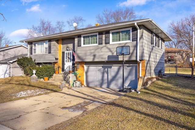 bi-level home featuring a front yard and a garage