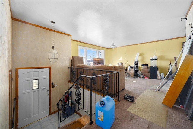 foyer entrance with carpet and ornamental molding