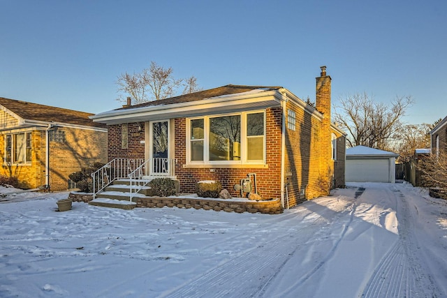 view of front of home featuring a garage and an outdoor structure